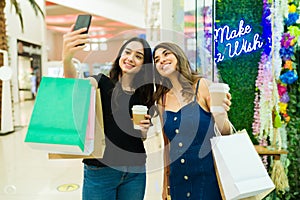 Best friends having fun while shopping at the mall