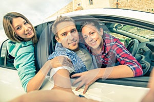 Best friends having fun together at car trip on the road