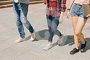 Legs of students walking down the road
