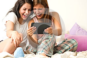 Best friends laughing browsing social network photo