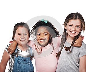 Best friends make you feel your best. Studio portrait of a group of three happy girls embracing one another against a