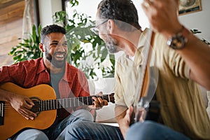 Best friends, musician jamming together. Playing music on guitar together, having fun. Concept of male friendship photo