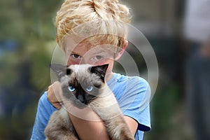 Best friends, schoolboy and his little cat