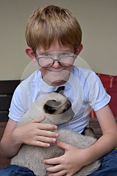 Best friends, schoolboy and his little cat