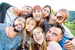 Best friends taking funny selfie at picnic excursion sticking out tongue - Youth life style concept with young people having fun