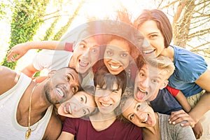 Best friends taking happy selfie outdoor with back lighting