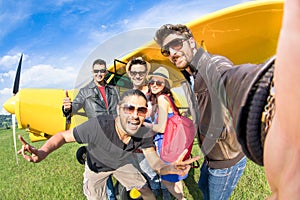 Best friends taking selfie at aeroclub with ultra light airplane