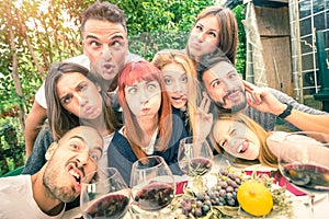 Best friends taking selfie at reatsurant drinking wine