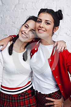 Best friends teenage girls together having fun, posing emotional on white background, besties happy smiling, lifestyle