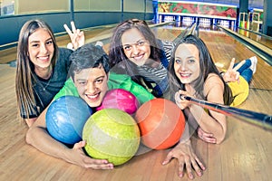 Best friends using selfie stick taking pic on bowling track