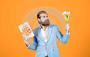 best gift ever. true gentleman with bouquet. love date concept. bearded man in formalwear with tulip flowers and box