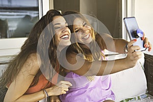 Best Girl Friends having Fun Together when they Taking Selfie from a Smart Phone.