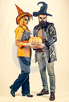 Best ideas for Halloween. Beauty Halloween girl and Handsome bearded man hold pumpkin on isolated background. Full