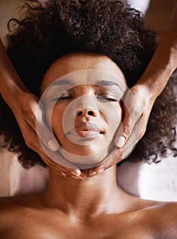 The best kind of stress relief...a young woman getting a head massage at a beauty spa.