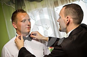 Best man dressing groom