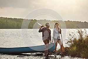 The best marriages are built on teamwork. a young couple going for a canoe ride on the lake.