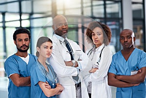 The best in the medical field. Portrait of a confident group of doctors standing with their arms folded inside of a