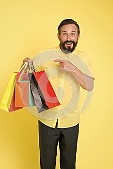 Best outfit ever. brutal caucasian hipster with moustache. Bearded man with shopping bags. Happy holidays. big sale in