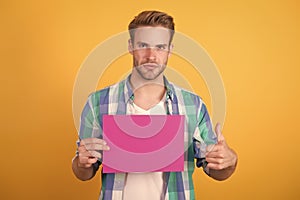 Best publicity stunt. Handsome guy give thumbs up holding pink paper sheet. Publicity and advertising. Advertising and