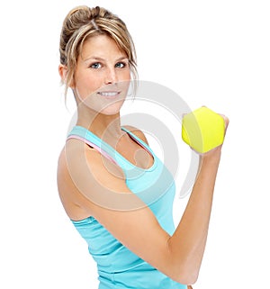 In the best shape ever. Attractive young woman in sportswear lifting dumbbells while isolated on white.