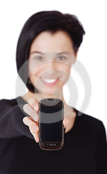This is the best smartphone on the market. Portrait of an attractive young woman holding out a cellphone against a white
