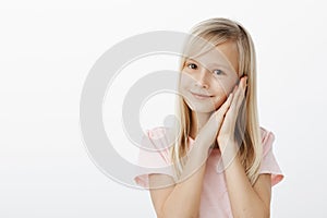 Best time spending is sleep. Portrait of friendly-looking adorable female child with blond hair, smiling cheerfully and