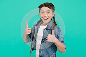 Best version of you. Happy kid give thumbs ups blue background. Little girl smile gesturing thumbs ups. Approval gesture