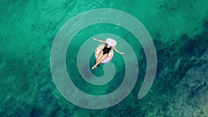 The best way to relax. 4k video footage of an unrecognizable young woman sitting on a lilo while floating on the ocean.