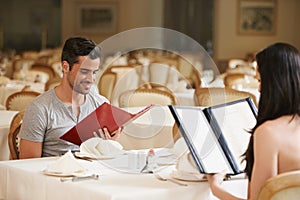 Only the best for you. A happy young couple on a date at a fancy restaurant.