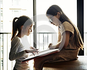 Bestfriends reading a book concept photo