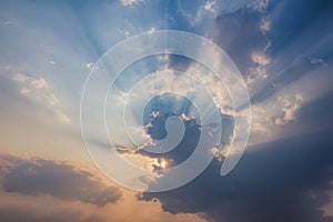 Besutiful ray of sunlight breaking through clouds at sunset