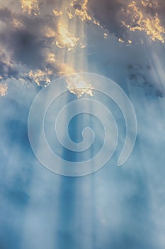 Besutiful ray of sunlight breaking through clouds at sunset