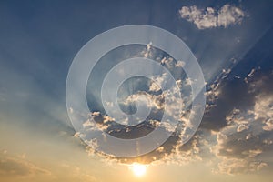 Besutiful ray of sunlight breaking through clouds at sunset