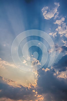 Besutiful ray of sunlight breaking through clouds at sunset