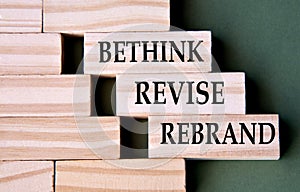 BETHINK REVISE REBRAND - words on wooden blocks on dark green background