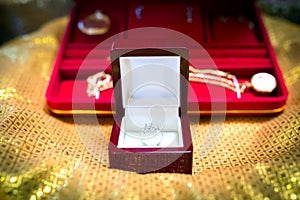 Betrothal wedding ring and gold necklace. - Selective focus