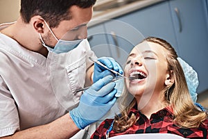 For a better looking tomorrow. Teen at the dental office. Dentist examining girl`s teeth in clinic.