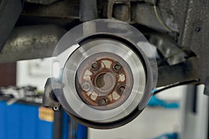 For better performance of a car. Close up of braking disc of the vehicle with brake caliper for repair in process of new