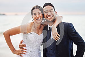 For better or worse, in sickness and health, for richer or poorer. Shot of a young couple on the beach on their wedding