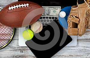 Betting on various sports with computer technology and money in photo