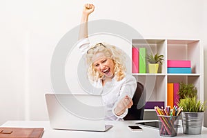 Beuatifull woman at the office celebrating her success