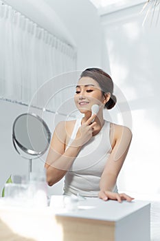 Beutiful asian woman doing skin treatment her self at home. galvanic facial