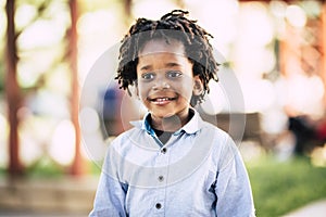 Beutiful black african people children portrait with park outdoor defocused background - color and skin race diversity child photo