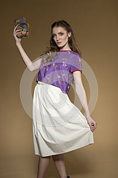 Beutiful model in summer elegant dress with colourful bag