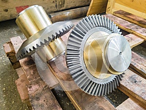 Bevel gears with a bronze insert on a mandrel after fabrication on gear cutting equipment