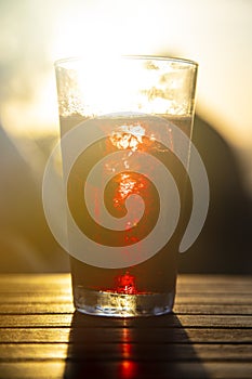 Beverage against the sun in sunset