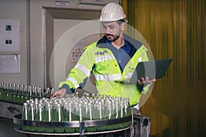 Beverage factory production line engineer checking production line