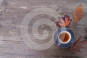 Beverage, hot drink in a mug, leaves, foliage, garland, candles, top view of wooden table, good weather concept, outdoor tea party