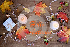 beverage, hot drink in a mug, leaves, foliage, garland, candles, top view of wooden table, good weather concept, outdoor tea party