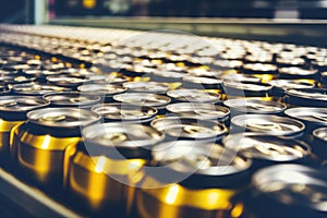 Beverage manufacturing: shiny aluminum cans moving on a conveyor in an industrial plant